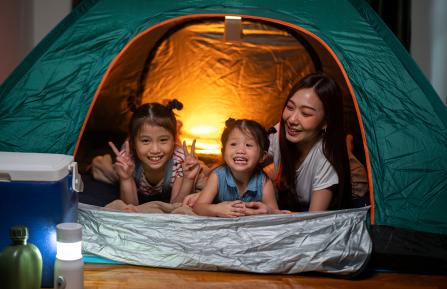 Asian family camping inside 