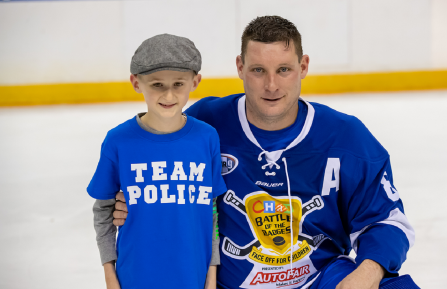 (L-R) Elliot Perry with Badges player Kyle Daly at the 2022 game. 