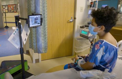 Photo of robot with patient