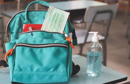 aqua backpack on school desk