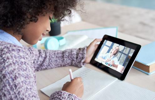 African-American girl remote learning using tablet.