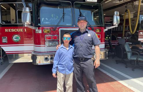 Buddy Izayiah visits his Badges Baseball player, Manchester firefighter Adam Langlois